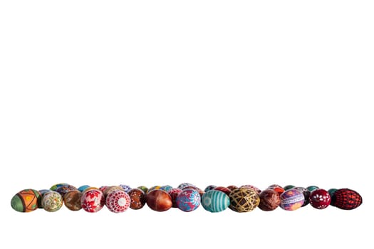 Original Easter eggs arranged one next to the other in different colors and patterns on a solid white background. Easter decoration to complete on your own.