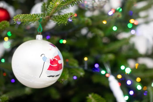 Christams tree with bauble. White bauble with Santa Claus.