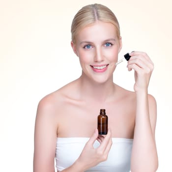 Personable portrait of beautiful woman applying essential oil bottle for skincare product. CBD oil dropper pipette for treatment and extracted cannabis concept in isolated background.
