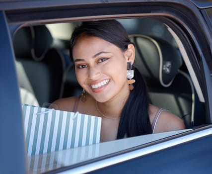 Shopping, happy and portrait of a woman in a cab for transportation after retail in the city. Smile, happiness and a girl with bags from fashion, store or boutique in a taxi car for transport.