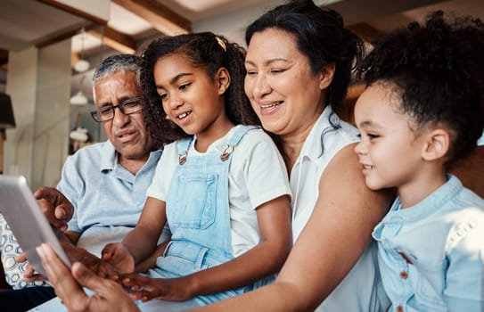 Family, relax and girl with tablet in home living room for social media, video streaming or web browsing. Technology, smile or care of happy grandfather, grandma and children bonding with touchscreen.