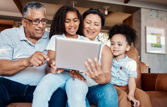 Family, relax and girl with tablet on sofa in home living room for social media or funny video streaming. Technology, care and happy grandfather, grandma and kids laughing or bonding with touchscreen.