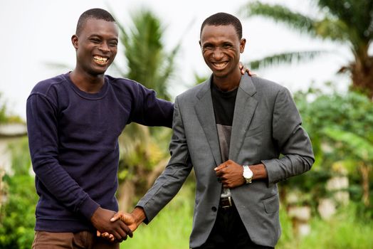 meeting of two young business people standing in a field and greeting each other.business concept and success