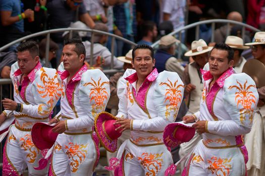 Oruro, Bolivia - February 26, 2017: Caporales dancers in ornate costumes performing as they parade through the mining city of Oruro on the Altiplano of Bolivia during the annual carnival.