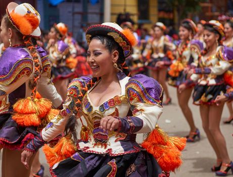 Oruro, Bolivia - February 26, 2017: Caporales dancers in ornate costumes performing as they parade through the mining city of Oruro on the Altiplano of Bolivia during the annual carnival.