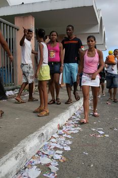 salvador, bahia, brazil - october 1, 2006: candidates' flyers are seen tossed on the street next to an electoral session in the city of Salvador.