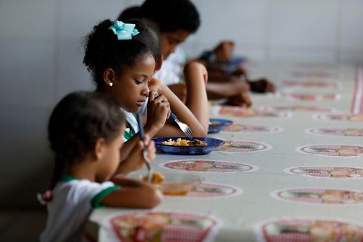 pojuca, bahia, brazil - august 1, 2019: Students from a public school in the city of Pojuca are seen having a meal.