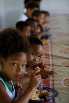 pojuca, bahia, brazil - august 1, 2019: Students from a public school in the city of Pojuca are seen having a meal.