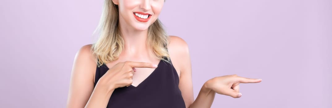 Closeup Alluring beautiful perfect makeup clean skin woman portrait pointing finger side way in copyspace isolated background. Promotion indicated by hand gesture concept for skincare advertisement.