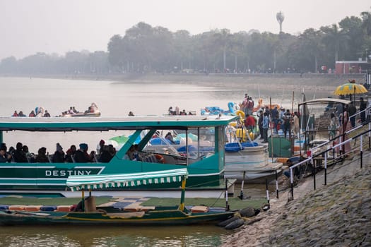 boats parked on the shore of sukhna lake ready for tourists to enjoy time on this man made lake in this popular city of chandigarh