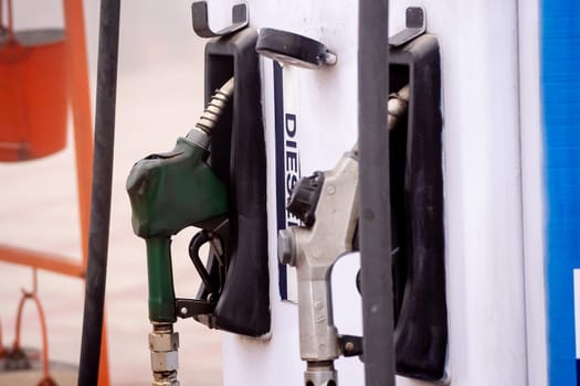 old damaged fuel pump nozzle showing petrol and deisel in india as the price increases and electric vehicles take over globally