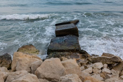 The beautiful coast of the city of Varna in Bulgaria. The sea beats against the stones, amazing seascape.