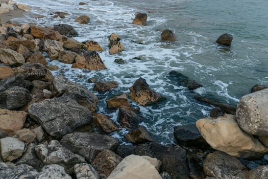 The beautiful coast of the city of Varna in Bulgaria. The sea beats against the stones, amazing seascape.