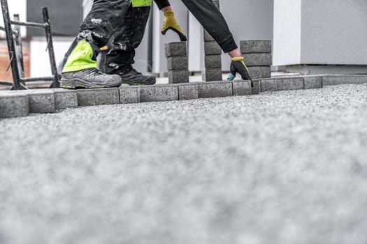 laying interlocking pavers during the construction of sidewalks and roads.