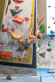 climbing on a boulder wall in a climbing center. High quality photo
