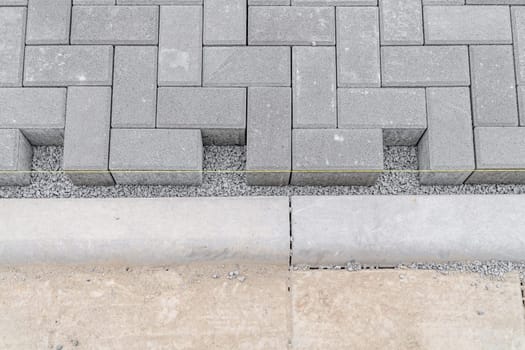 building a sidewalk, laying interlocking pavers.