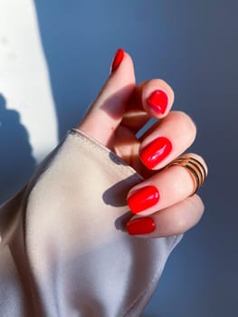 Beautiful nails manicure photo. Red color top nail polish. Female hand, rings, closeup photo, aesthetics. Manicure design, square nail shape. Luxury style, Creative beauty photo, Woman hand. High quality photo. High quality photo. High quality photo