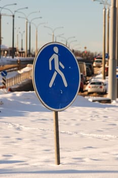 Road sign pedestrian zone among the snow close up