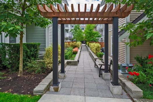 Quiet walkway in residential area between two rows of townhouses.