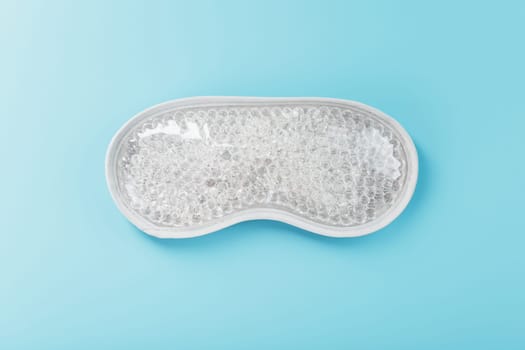 Reusable gel eye mask for swollen eyes on a blue background