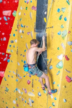 climber with safety rope on an artificial climbing wall. High quality photo