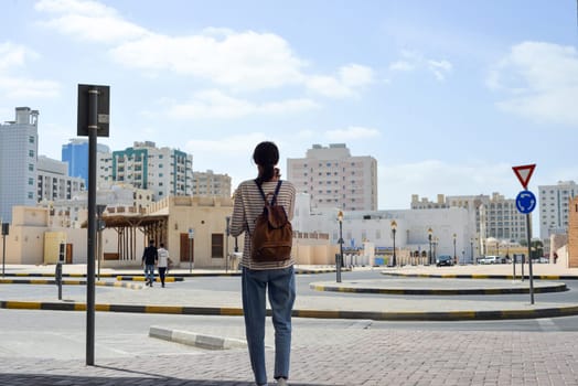 Woman tourist with a backpack on the Arab streets in the old part of Sharjah, UAE