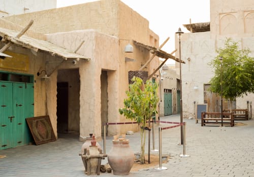 Narrow streets that create shade on a hot day in the old city of Dubai Creek and Bur district. Travel destinations and heritage village.