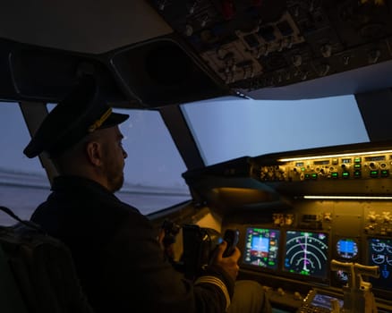 A man is studying to be a pilot in an aircraft simulator