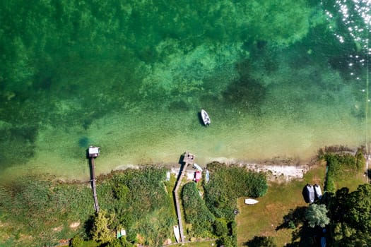 Aerial top view of the lake coast and piers. Beautiful coastline Bodensee lake