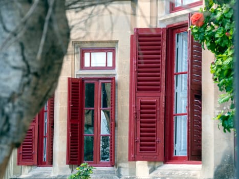 Fragment of the building's facade with traditional wooden ornate balconies painted in Valletta, Malta. High quality photo