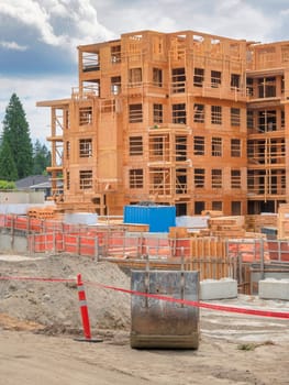 Construction of the residential building with excavator bucket in front