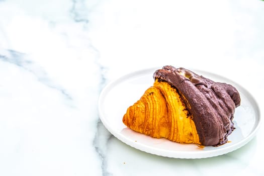 croissant with  chocolate on top.  breakfast background