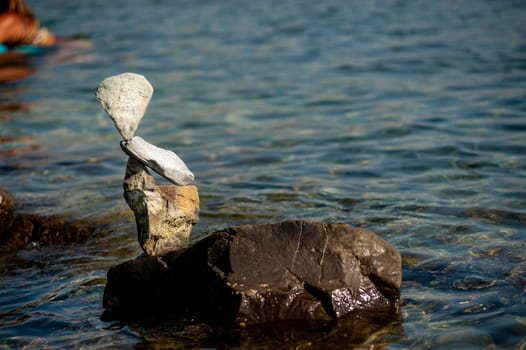 balanced stones on the rocks of the sea