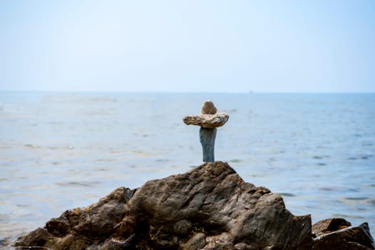 balanced stones on the rocks of the sea