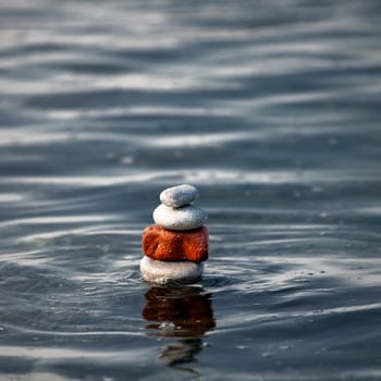 balanced stones on the rocks of the sea