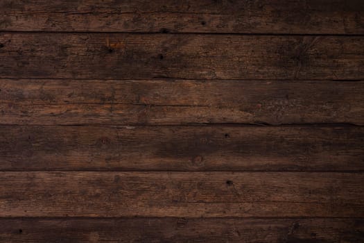 Several horizontally stacked old boards in clothes of brown color. Background of natural material slightly tattered.