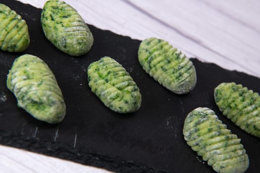 Pile of green spinach gnocchi, potato peru italian food, Homemade, High quality photo