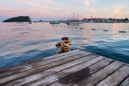 A very beautiful sunset on the pier, a beautiful sky on the sea, against the backdrop of a pier and a pier with yachts against the backdrop of a resort town