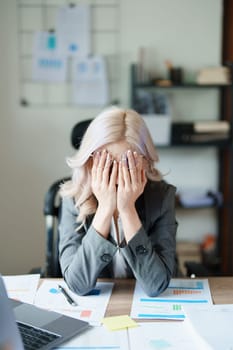 Portrait of sme business owner, woman using computer and financial statements Anxious expression on expanding the market to increase the ability to invest in business.