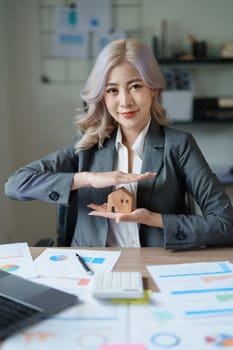 portrait of an asian man, Agent, buy and sell land, property tax, show the concept of protecting the house to insure the risk of damage to the home.