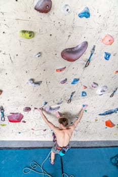 climber with safety rope on an artificial climbing wall. High quality photo