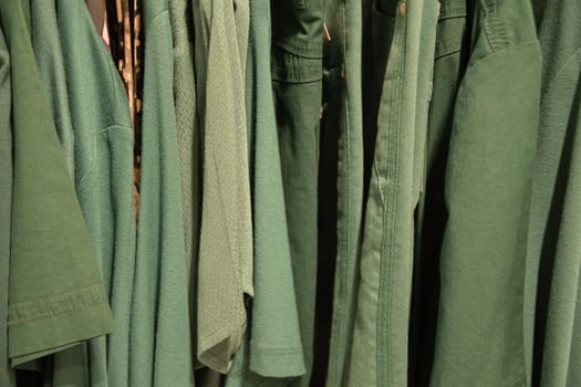 green summer blouses on a hanger in the store, bright summer clothes, High quality photo