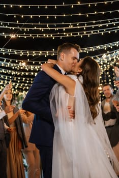 newlyweds at a wedding in the corridor of sparklers