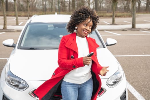 cheerful african american woman goes to car and holding keys,Motion blurred, High quality photo