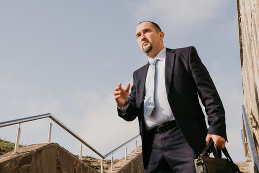 Business executive with briefcase going down the stairs.