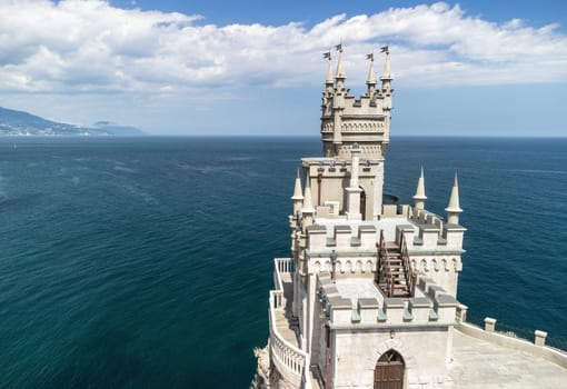 Aerial view of Swallow's Nest castle on the rock in Black Sea. It is a symbol and landmark of Crimea. Beautiful scenic panorama of the Crimea coast. Amazing Swallow's Nest at the precipice.