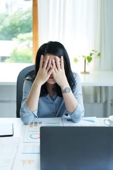 Portrait of sme business owner, woman using computer and financial statements Anxious expression on expanding the market to increase the ability to invest in business.