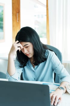 Portrait of sme business owner, woman using computer and financial statements Anxious expression on expanding the market to increase the ability to invest in business.