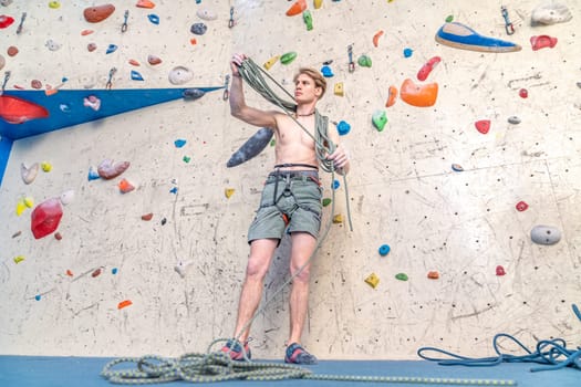 winding of a climbing rope by a young climber. High quality photo