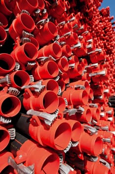 Bunches of PVC pipe sitting on palets at a wholesale pipe store.